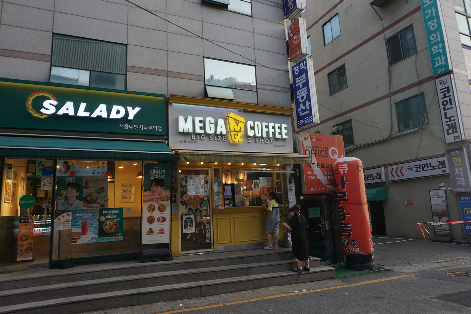 A Walk up coffee shop with customers waiting outside