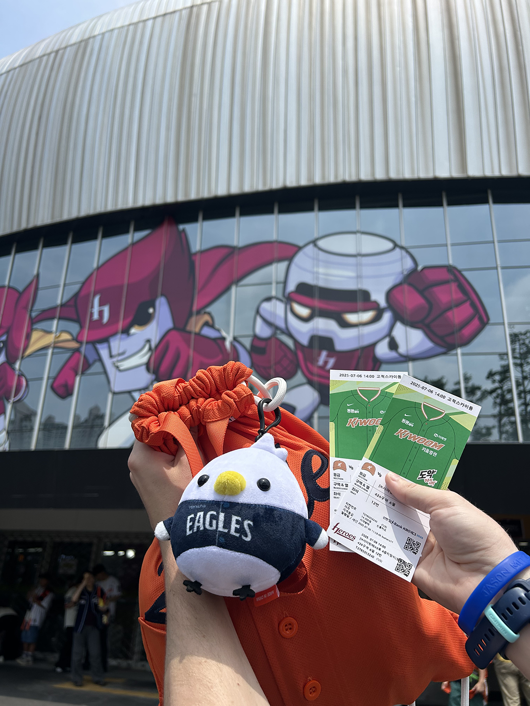 Various Merch Items of the Hanhwa Eagles being held up in front of the stadium