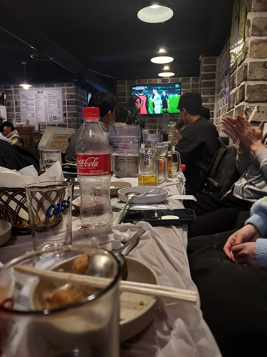Customers at a chicken restaurant watch a World Cup Game