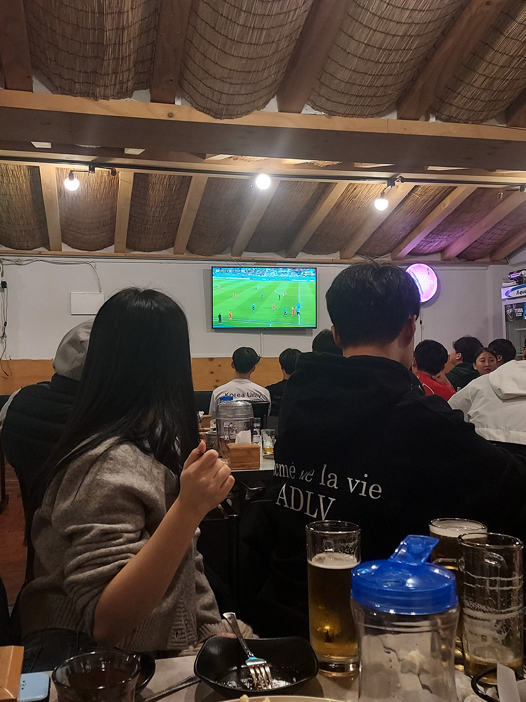 Customers at a different chicken restaurant watch a different World Cup Game