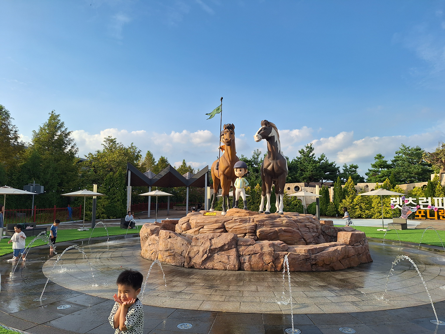 Pony Land with 2 horse sculptures in the middle of a fountain