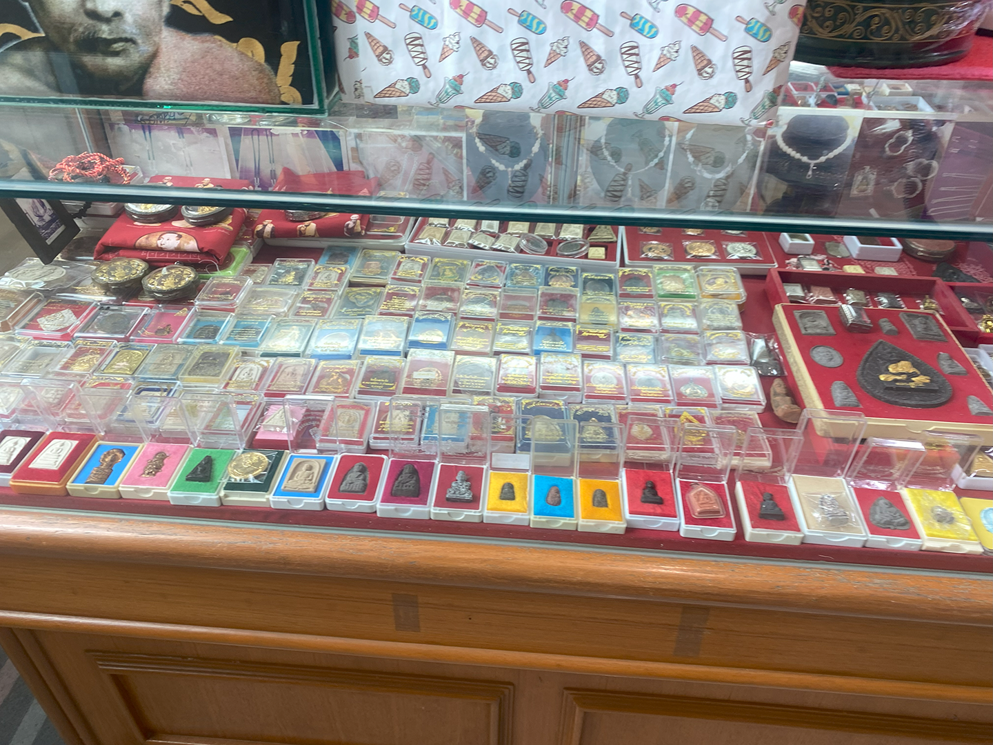 Another Amulet Seller's table, but with each amulet in its own designated small case